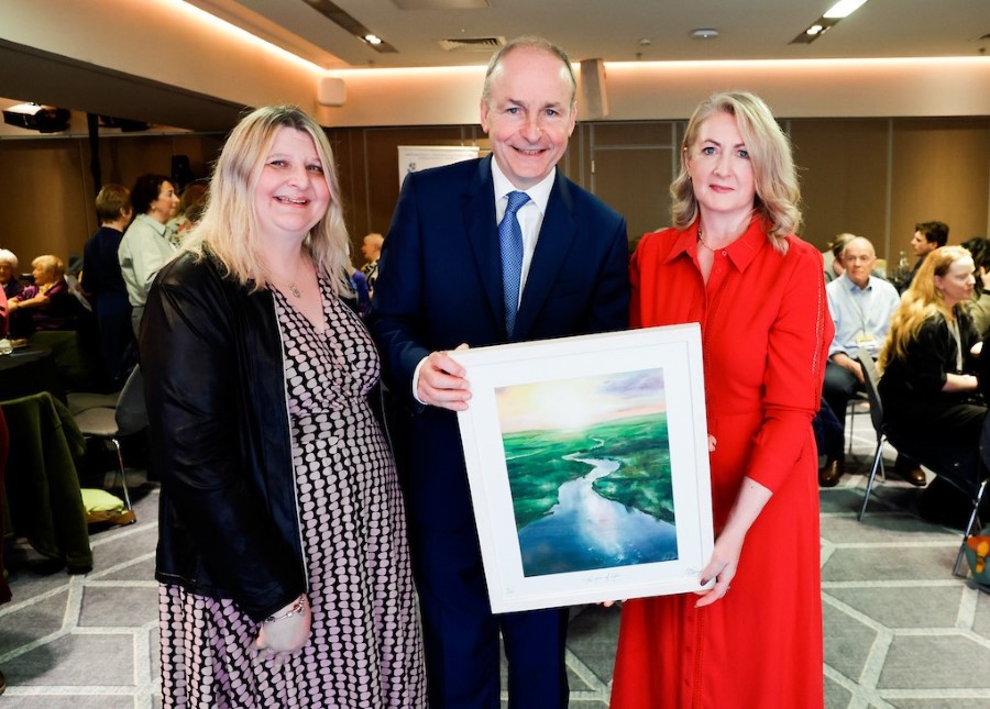 Emma Clancy, County Librarian and Creative Cavan Coordinator (right) joins Allison Forbes, Project Manager of South-West Age Partnership (left) in presenting An Taoiseach Micheál Martin with an artwork by Cavan Artist Kim Gaffney.
