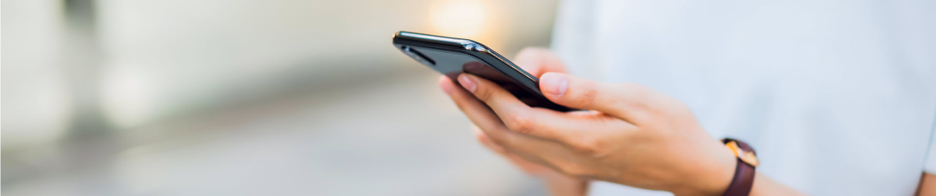 woman hand using black smartphone